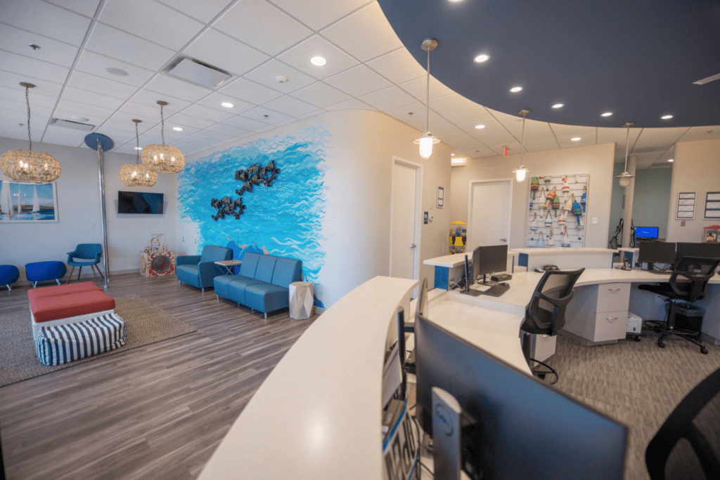 Potomac Pediatric Dentistry - Family Dentistry and Orthodontics Angled shot of the front desk and waiting room of Woodbridge pediatric dentist and orthodontist Potomac Pediatric Dentistry